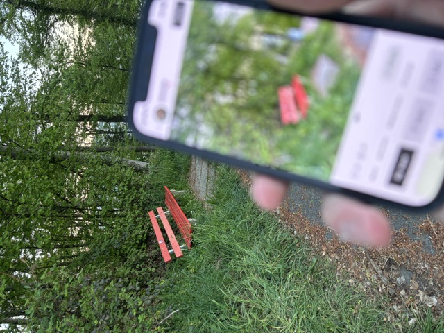 Picture of the Cranny app infront of a bench in a forest